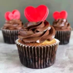 Three delicious cupcakes with chocolate frosting and a YouTube logo on top.