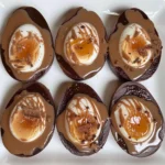 Assortment of chocolate Easter eggs in various designs and fillings.