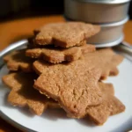 Star-shaped ginger biscuits in a metal tin.