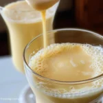 Two glasses of Pipoca Líquida, a creamy light-yellow beverage.